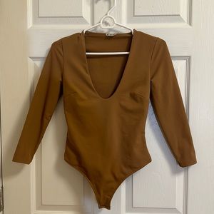 Free People Tan Bodysuit. Deep V-neckline. Button closure. Size X-Small.